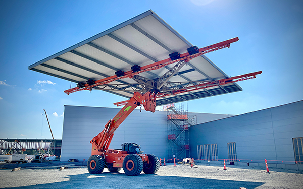 BZI Wall Master™ Vehicle Carries A Large Section Of Insulated Metal Panels To Building For Installation