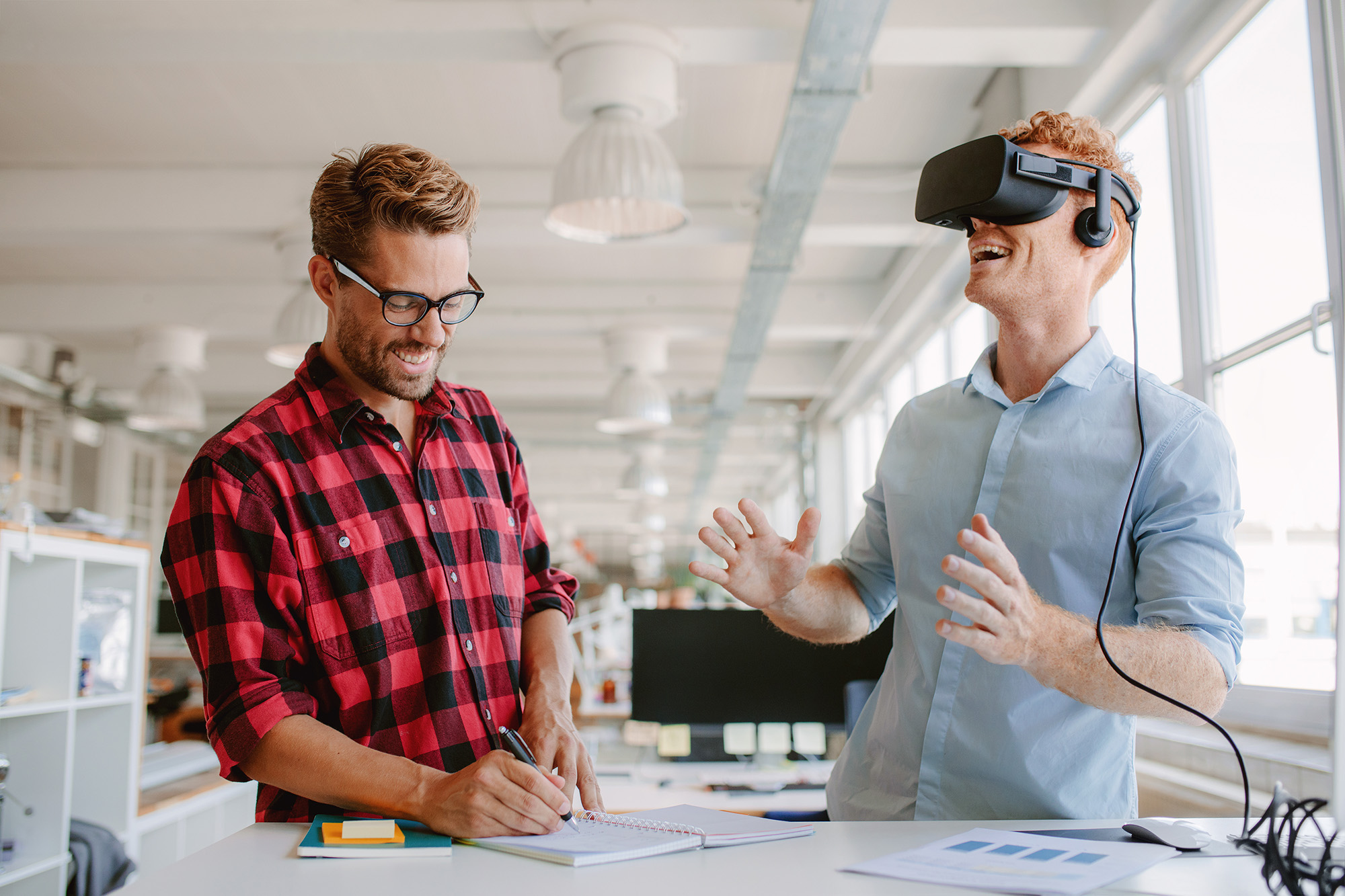 Two businessmen testing virtual reality headset