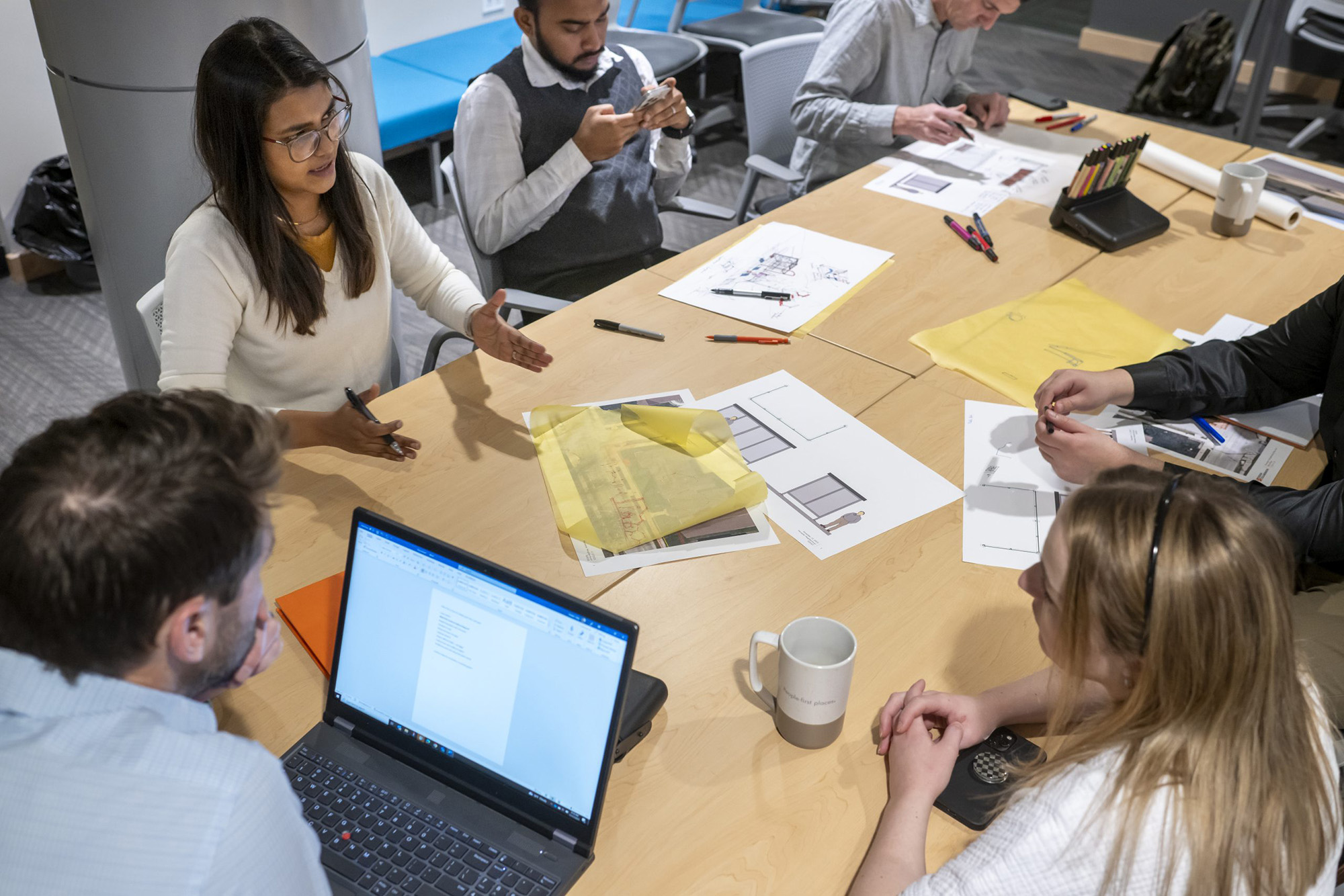 Office workers planning around a table