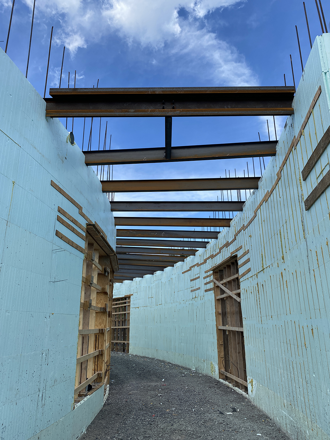 A photo of light blue curved ICF walls during building construction