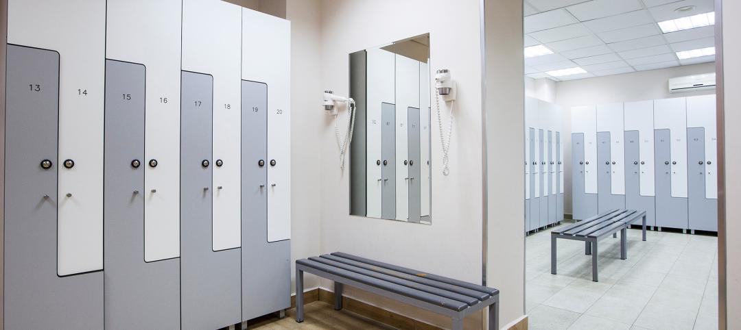 wide frame with a white locker room with wooden cabinets and benches and specific equipment