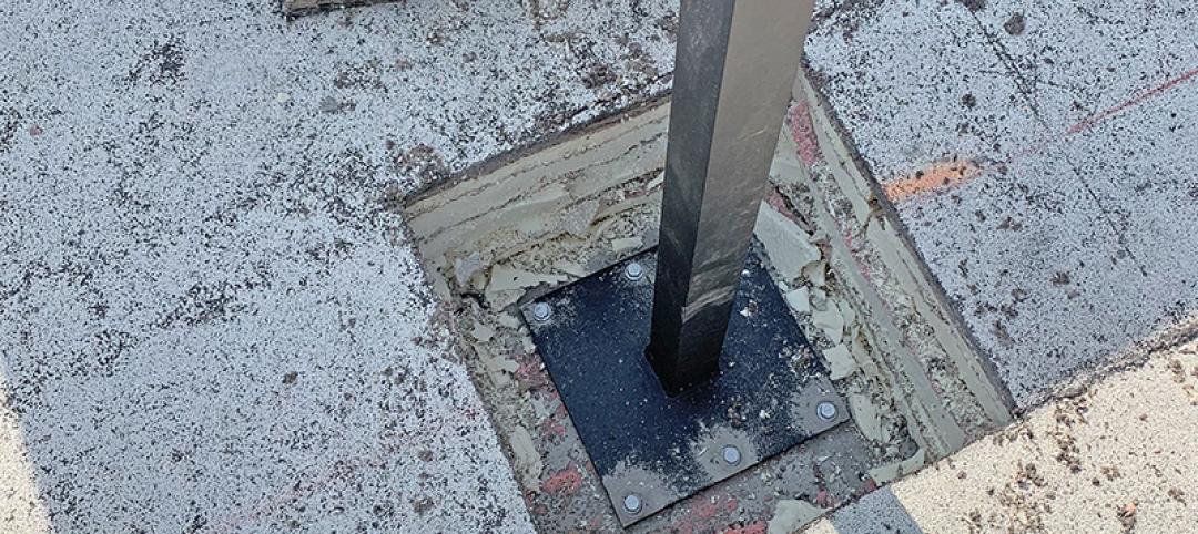 Hole in roof exposes specialized flange plate AVCON engineered to mount Ultra Aluminum commercial railing posts to rooftop terrace.